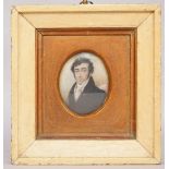 A miniature on ivory, 19th century depicting a gentleman in a black coat, framed and glazed,