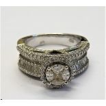 A white gold and diamond cluster ring, mounted with a central square diamond,