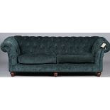 Kirkdale; a modern teal upholstered Chesterfield style sofa on turned supports,