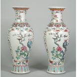 A pair of Chinese famille-rose slender baluster vases, circa 1900,