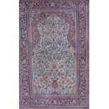 A Kashan prayer rug, Persian, the fawn mehrab with a vase filled with abundantly floral sprays,