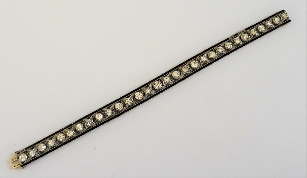 A diamond and black onyx line bracelet, circa 1930,