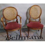 A set of eight Louis XVI style stained beech dining chairs with cane backs on fluted tapering
