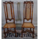 A pair of early 19th century continental stained beech high back chairs with cane seats,