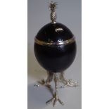 A black painted ostrich egg converted into a lidded trinket pot,