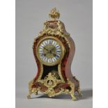 A French giltmetal-mounted, tortoiseshell and cut brass-inlaid mantel clock In the Louis XV style,