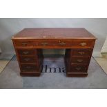 An early 20th century mahogany pedestal desk, with nine drawers about the knee,
