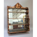 A Victorian gilt hanging waterfall four-tier wall shelf with pierced sides and mirror back,