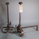 A pair of 18th century style steel fire dogs.