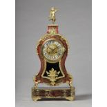 A French giltmetal-mounted tortoiseshell and cut brass-inlaid mantel clock In the Louis XV style,