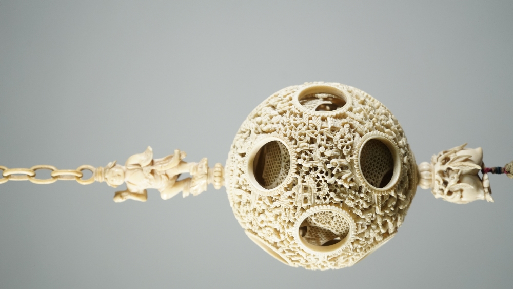 A Canton ivory puzzle ball, late 19th century, the outer ball pierced and carved with figures, - Image 3 of 6