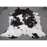 A modern cow hide rug, 220cm.