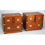 A pair of campaign style brass bound hardwood bedside cabinets each with two short over one long