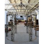 A green painted wrought iron onion topped gazebo with open trellis sides,