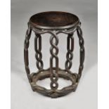 A late 19th century Chinese hardwood barrel stool, with open pierced interlaced supports,