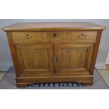 An early 20th century French Beech commode with three frieze drawers over cupboard base on bracket