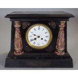 An early 20th century Egyptian Revival black slate cased mantel clock, 35cm wide.