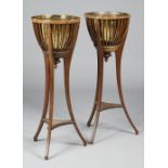 A pair of Edwardian mahogany jardinieres with open slatted brass lined bodies on three splayed