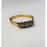 A gold and diamond set three stone ring,