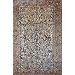 A fine silk Ghom rug, Persian, the ivory field with a central medallion, matching spandrels,