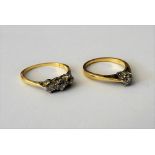 A gold and diamond set three stone ring, mounted with a row of variously cut diamonds,