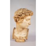 An 19th century style pottery bust depicting a Romanesque male, on a circular plinth,