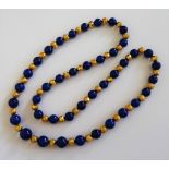 A lapis lazuli and gold bead single strand necklace,