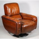 A modern brown leather upholstered swivel easy armchair on splayed polished metal base,