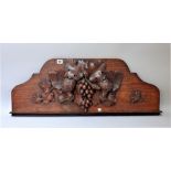 A 19th century German oak carving depicting two ho ho birds amongst fruiting vines,