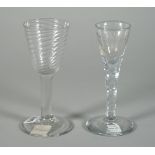 A plain stemmed wine glass, mid-18th century, with wrythen moulded rounded funnel bowl,