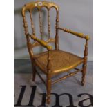 A Victorian child's gilt framed musical chair with turned supports 37cm wide x 65cm high.