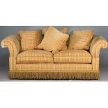 A modern yellow square check upholstered sofa with roll over arms and tassel frieze,