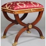 An Empire Revival gilt-metal mounted mahogany 'X' frame stool on paw feet, 47cm wide x 53cm high.