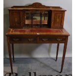 An Edwardian faux painted rosewood and inlaid two drawer writing desk on tapering square supports,