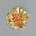 A gold, diamond and coral set pendant brooch, designed as a flowerhead,