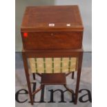 An Edwardian mahogany lift top sewing table with an undertier, 38cm wide x 81cm high.