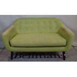 A 20th century hardwood framed two seater sofa with green button back upholstery on tapering