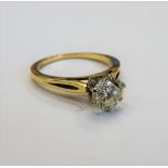 A gold and diamond single stone ring, claw set with a circular cut diamond, detailed 14 K,