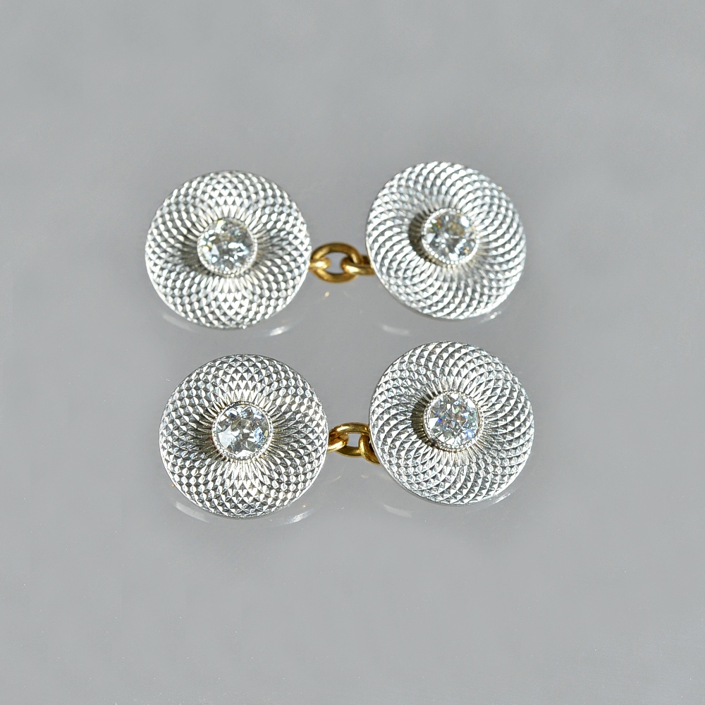 A pair of platinum and gold, diamond set dress cufflinks, with circular backs and fronts,