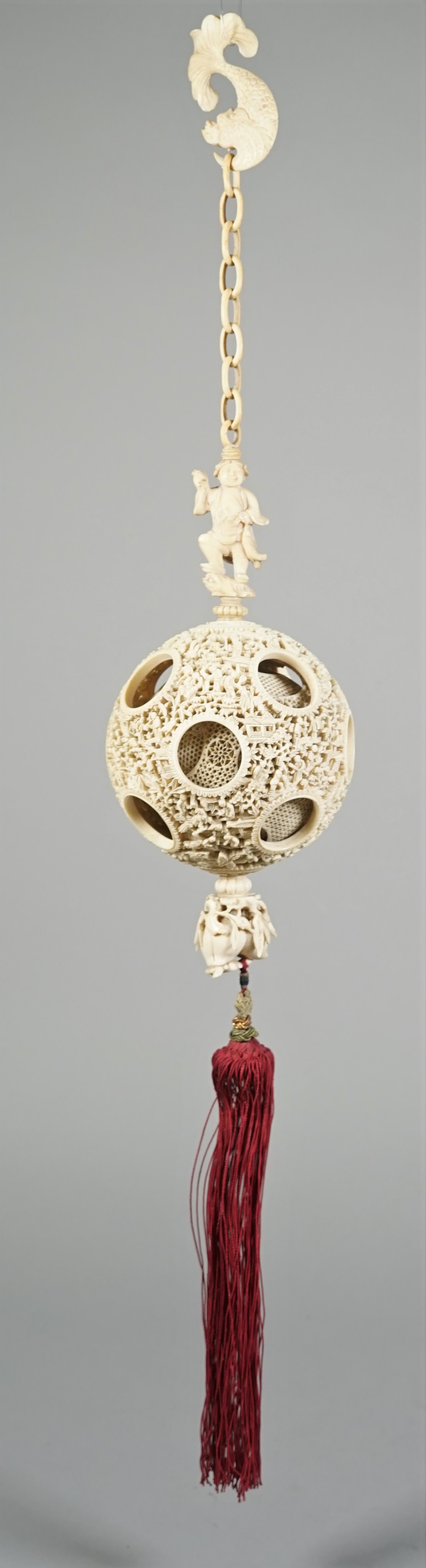 A Canton ivory puzzle ball, late 19th century, the outer ball pierced and carved with figures, - Image 2 of 6