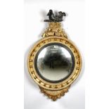 A Regency gilt framed convex mirror with unusual serpent surmount and starburst lower about the