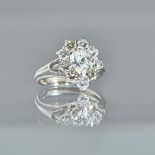 A white precious metal and diamond set ring of cluster design,
