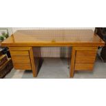 A 20th century walnut desk with two banks of three drawers, 170cm wide x 73cm high.