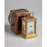 A French gilt brass and three-panel pink-ground porcelain carriage clock By François-Arsène