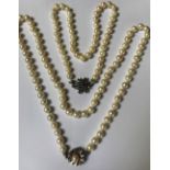 A single row necklace of uniform cultured pearls, on a white gold,