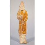 A Chinese pottery figure of a soldier, Sui dyansty, modelled standing in ochre glazed robes, 23.5cm.