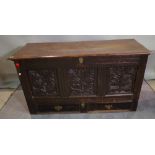 An 18th century and later oak coffer with three inset carved panels over two drawers,