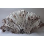 An ostrich feather fan from Sieradzkis, Johannesburg, with tortoiseshell sticks, 62cm,