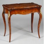 A Victorian gilt-metal mounted figured walnut card table with serpentine fold over top on cabriole