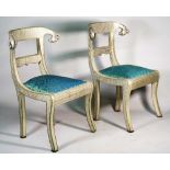 A pair of Anglo Indian style metal veneered side chairs with rams head finials on sabre supports,